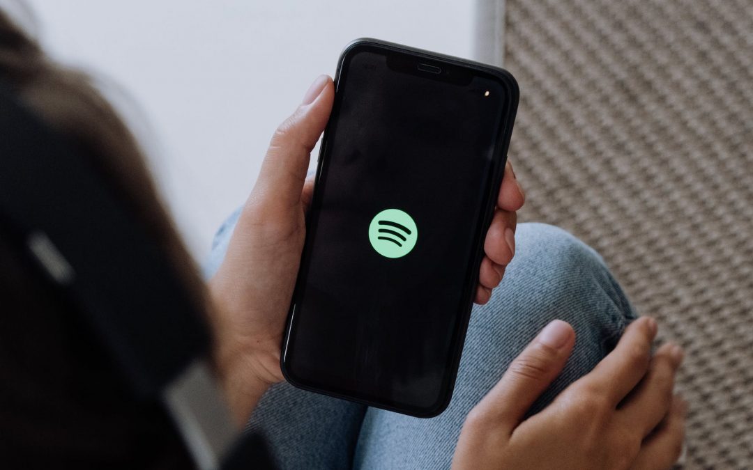 Person looking at the Spotify app on their phone